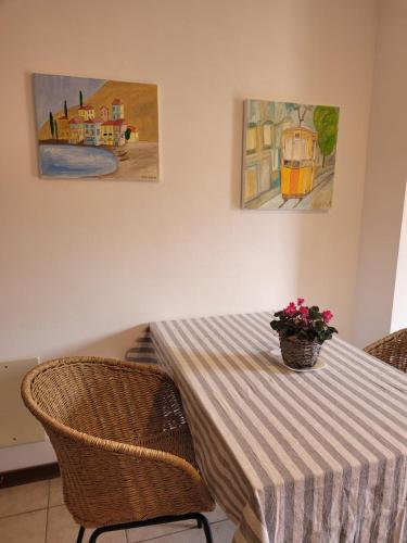 a dining room table with a vase of flowers on it at Blue Lake in Acquaseria