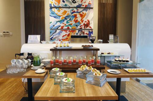 a buffet with food and drinks on a table at Horison Tasikmalaya in Tasikmalaya