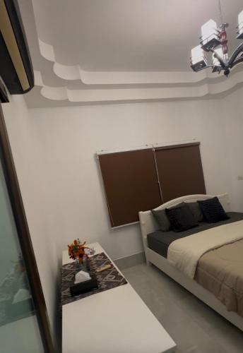 a bedroom with a bed and a table in it at Restaurant Mayuree in Kranuan
