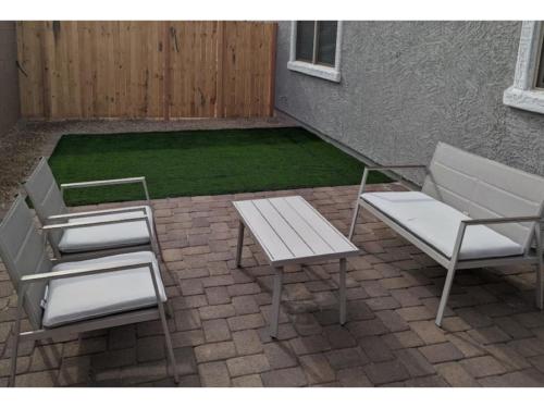 two chairs and a table and a bench on a patio at Cozy Southwest Style Hideaway with Mountain Views in Phoenix