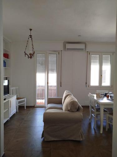 a living room with a couch and a table at Turquoise Horizon in Stintino