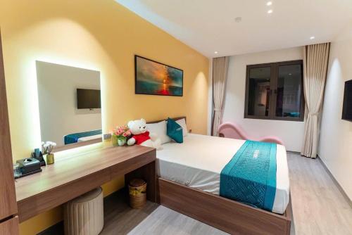 a bedroom with a bed with a teddy bear on it at Khách sạn XMen Thanh Hóa - Không gần biển in Thanh Hóa