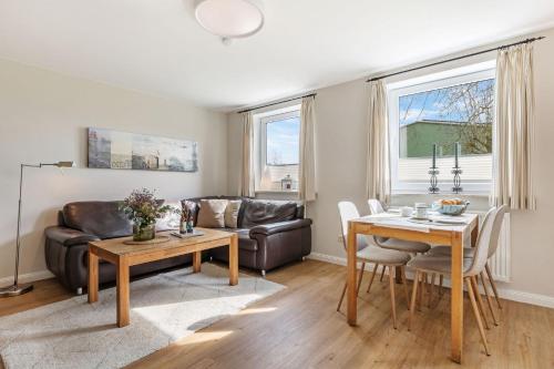 a living room with a couch and a table at Backhaus Ost in Bisdorf