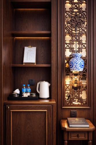 a cupboard with a blue and white vase on it at Eli Suites in Hanoi