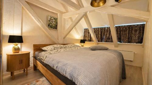 a bedroom with a large bed and a window at Kungs Ferienwohnung 2 in Cottbus