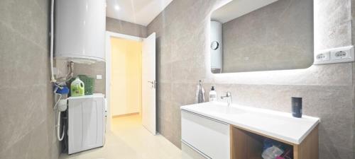 a white bathroom with a sink and a counter at Vista al Mar 2 Peñiscola in Peniscola