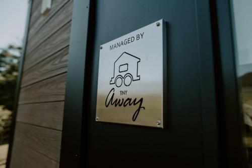 a sign on the door of a house at Nomad Nation by Tiny Away in Mount Perry