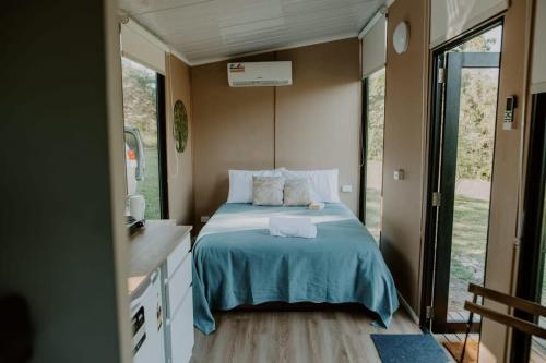 a small bedroom with a bed in a trailer at Nomad Nation by Tiny Away in Mount Perry