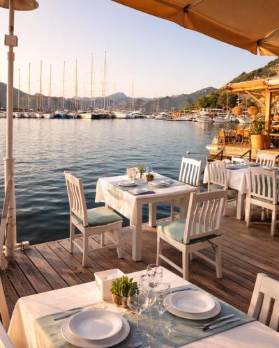 a table and chairs on a dock next to the water at Selimiye Çapkını in Marmaris