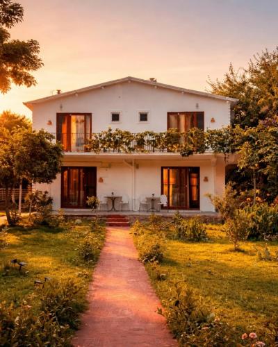 a white house with a pathway in front of it at Selimiye Çapkını in Marmaris