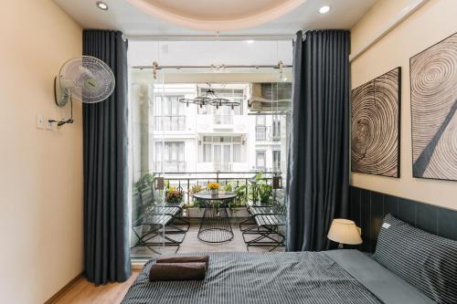 a bedroom with a bed and a balcony with a table at Supper Location City view 3Br 5CG in Hanoi