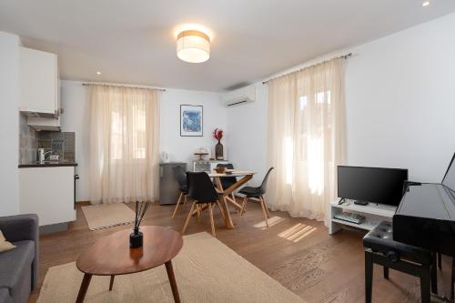 a living room with a couch and a table at Apartment Lassy by Irundo in Rovinj