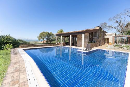a swimming pool in front of a house at Carreços Beach Farm in Viana do Castelo