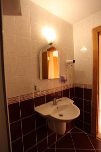 a bathroom with a sink and a mirror at Malhun Hotel in Fethiye