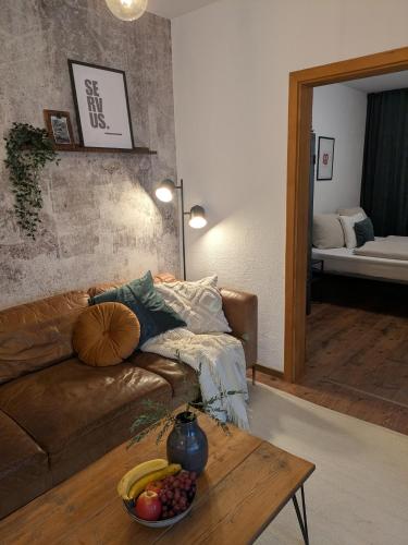 a living room with a couch and a table at Ferienwohnung Strizi inkl Chiemgau Karte in Ruhpolding