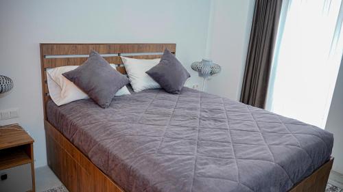 a bedroom with a large bed with pillows at Chechakar Boutique Hotel in Ditavan