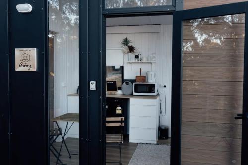 a door leading into a kitchen with a counter at Tiny Tamborine 1 by Tiny Away in Wongawallan