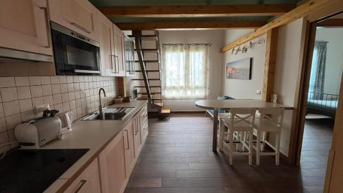 a kitchen with a sink and a counter top at Bombyx Inn in Bergamo