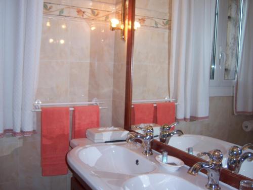 a bathroom with a sink and a mirror at Bastide Rose de Mai in Le Rouret