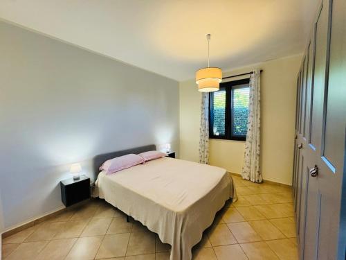 a bedroom with a bed and a window at Villa Giovanna - Residence with Pool in Campofelice di Roccella