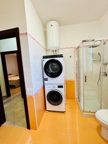 a washing machine in a bathroom with a toilet at Villa Giovanna - Residence with Pool in Campofelice di Roccella
