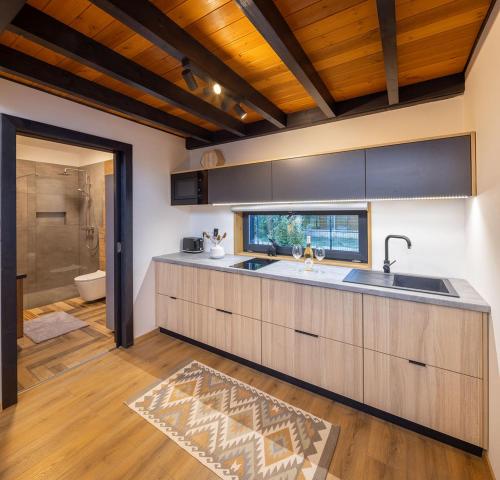 a large kitchen with a sink and a shower at White Lotus Mini Loft House in Mezőkövesd