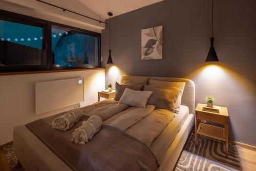 a bedroom with a large bed with two pillows on it at White Lotus Mini Loft House in Mezőkövesd