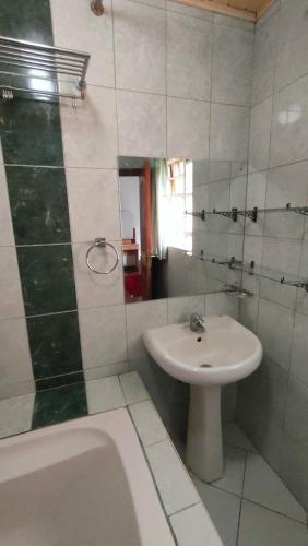 a bathroom with a sink and a toilet and a tub at rossylyn lonetree two bed bedroom in Nairobi
