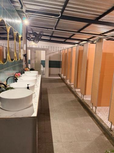 a row of sinks in a public bathroom at Malila Sea Breeze Hostel in Ko Tao