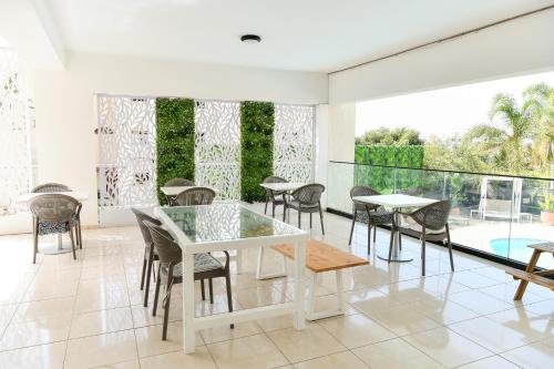 a dining room with a white table and chairs at King's Holiday Apartments in Paphos