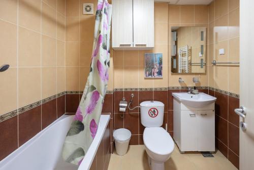 a bathroom with a toilet and a sink at Apartment Orchid 021 in Novi Sad