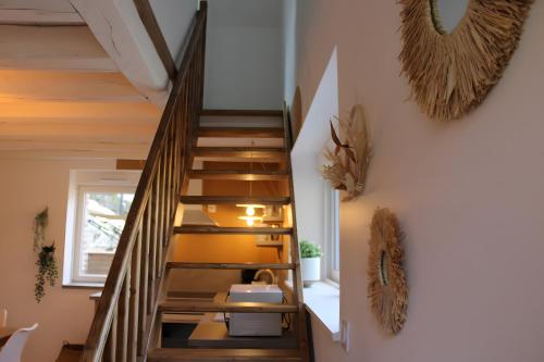 a staircase in a house with wooden floors and a window at Gîtes La Grenouillère in Veuzain-sur-Loire