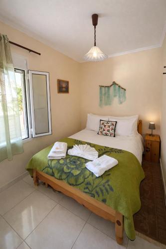 a bedroom with a bed with towels on it at Asterias in Koronisía