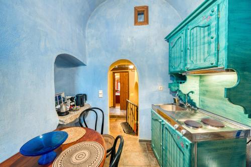 a kitchen with a table and a sink at Mesaionas 2 in Olýmpoi