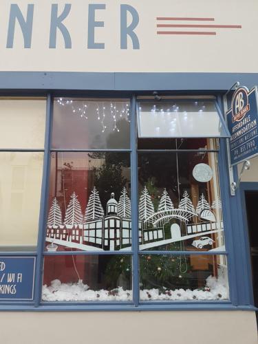 a window of a store with christmas decorations in it at Archies Bunker Affordable Accommodation in Napier