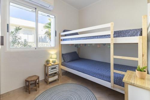 a bedroom with two bunk beds and a window at Beachfront Rental Home & Sea Views by Invalencia in Sagunto