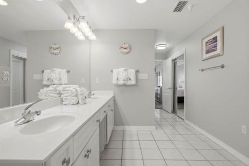 a white bathroom with a sink and a mirror at Marlin Key 2A in Orange Beach