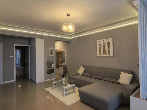 a living room with a couch and a table at Sunny Apartment in Oradea