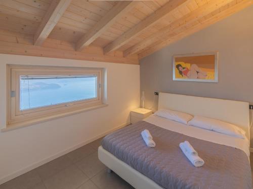 a bedroom with a bed and a window at EnjoyIseoLake - Lake View Paradise in Parzanica