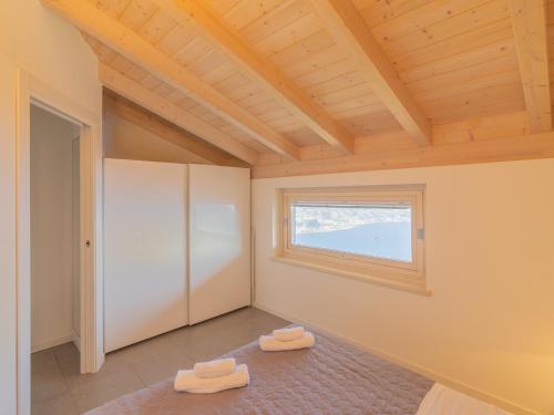a room with a window and two towels on the floor at EnjoyIseoLake - Lake View Paradise in Parzanica