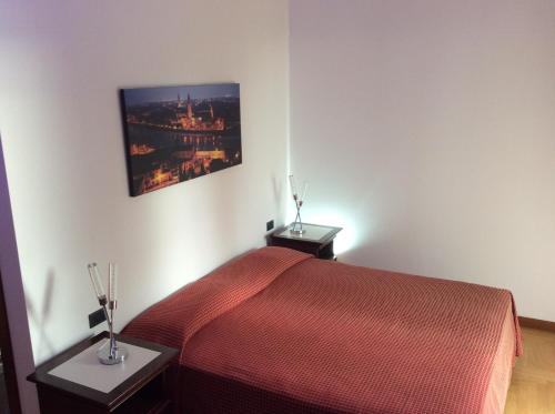 a bedroom with a red bed and two night stands at Magellano Room in Verona