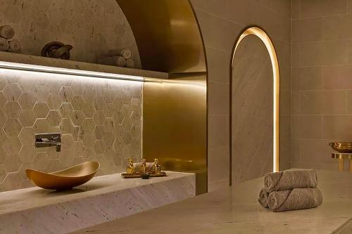 a bathroom with a sink and a bowl on a counter at Palace Dubai Creek Harbour in Dubai