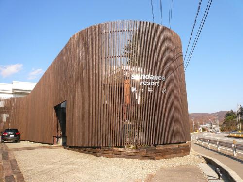 a wooden building with a painting on the side of it at Sundance Resort Karuizawa in Karuizawa