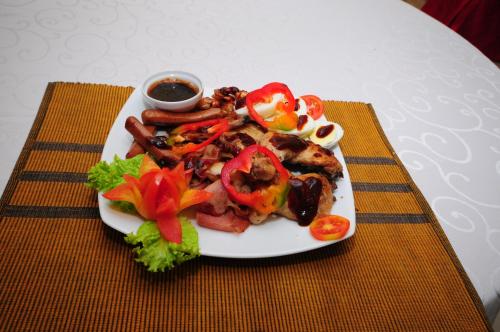 a plate of food with vegetables on a table at Hotel Sobana Lake front in Udawalawe