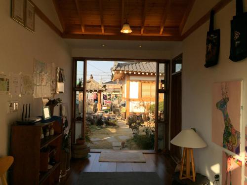 a living room with a door open to a patio at Dorandoran Guesthouse in Gyeongju