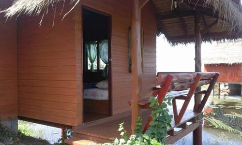a small cabin with a bed in the doorway at Lungcha Homestay in Sam Roi Yot