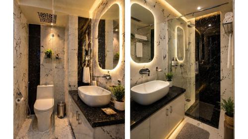 a bathroom with two sinks and two mirrors at MAHFIL-e-MOTIJHEEL, MOTIJHEEL PARK AND RESORT in Lālbāgh