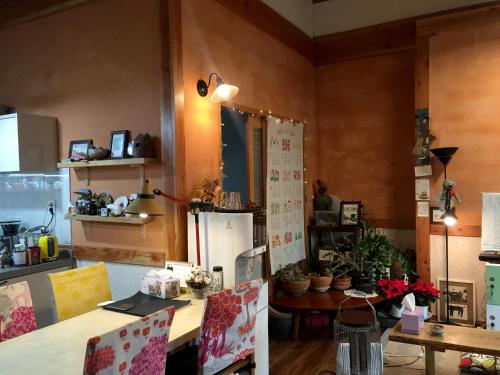 a kitchen with a table and a refrigerator at Dorandoran Guesthouse in Gyeongju