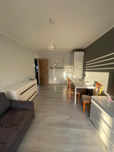 a living room with a kitchen and a dining room at U Damiana in Gdańsk