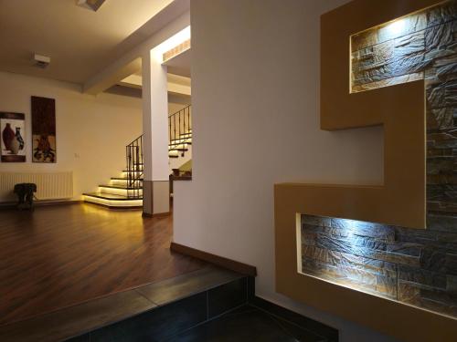 a living room with a staircase and a brick wall at Makadam Hotel in Prizren
